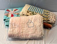 Stack showing all three quilts folded