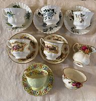 Group shot: six teacup & saucer sets, Old Country Roses creamer and sugar