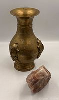 Brass dragon vase front view with pink quartz piece
