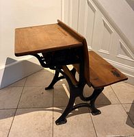 Side view showing oak top, iron frame, fold-up seat