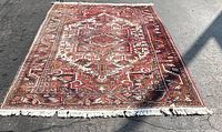 Full view of Persian Heriz rug laid flat outdoors