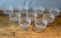 All nine sherbet dishes grouped on tabletop showing overall condition