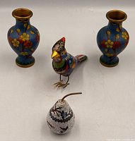Group shot of two vases, bird figurine and pear jar