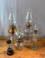 Group shot of all five glass oil lamps