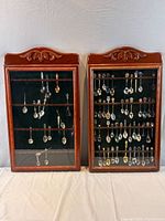 Both display cases filled with souvenir spoons