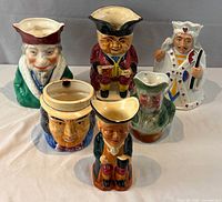 Front view of all six Toby jugs