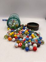Jar tipped, marbles spilled showing quantity and colour variety