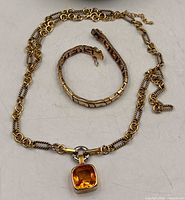 Necklace and bracelet laid out to show design and lengths