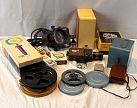 Group shot of camera, light, reels, case, boxes