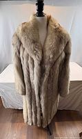 Front view of full-length Herman Furs coat on mannequin
