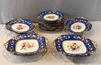 Stack of 11 plates with four serving dishes showing pattern and sizes