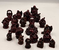 Group shot of all 20 red resin Laughing Buddha figurines