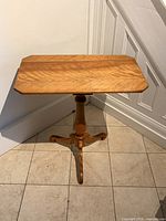 Full view of side table showing top, pedestal, legs