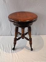 Full view of stool showing seat, legs, and claw feet