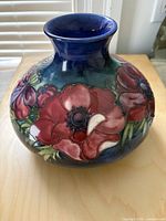 Front view of Moorcroft squat vase showing floral decoration