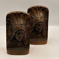 front view of both bronze bookends showing Native American bust relief and patina