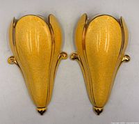 Front view of both yellow and gold ceramic wall vases