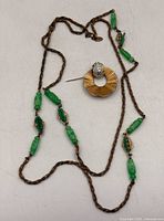 Full view showing entire necklace and brooch