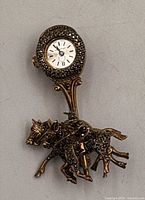 Front view showing horse racing design and watch face with marcasite setting