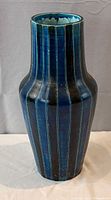 frontal view of tall blue striped vase