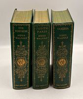 Spine view of all three books showing gilt decoration and titles