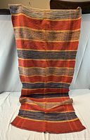 Full view of runner rug laid out to show length and stripe pattern