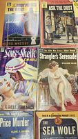 Group of six vintage Dell and Pocket Book paperbacks showing titles and cover art