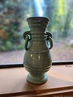 Full view of celadon glazed vase showing shape and handles