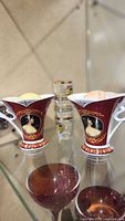 Two Britain tea cups, stack of four Mannheim shot glasses in background