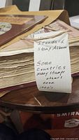 Spine view of thick album with handwritten note indicating contents
