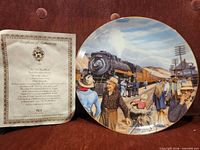 Front view of one plate alongside certificate of authenticity