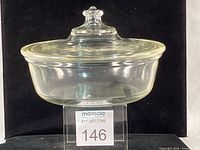 Side view of casserole with lid on stand