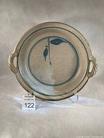 Front view showing entire dish, handles, glaze and motif