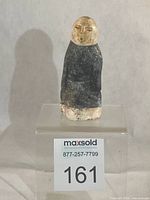 Full front view of stone carving on display stand