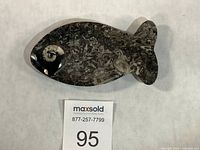 Full view of fish-shaped black marble dish