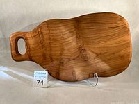 Front view of maple cutting board on stand