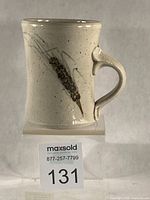 Front view of mug showing wheat shaft motif and handle