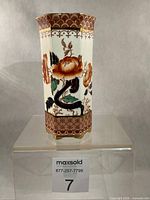 Front view of hexagonal Imari vase showing floral decoration and honeycomb border