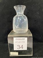 Front view of clear textured sack vase on display block