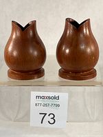 Front view of both yew wood candlesticks on bases