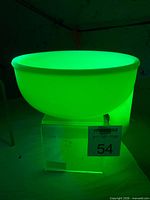 Side view of glowing jadeite bowl under UV