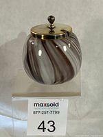 Front view of swirled glass jar with lid