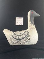 Front angled view of paper-mache Nēnē goose showing overall form and painted symbols