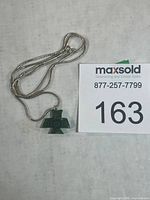 Entire pendant with chain coiled