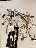Group shot of approximately 35 wristwatches on table