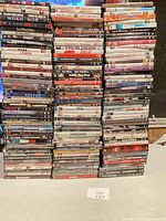 Front view of four tall stacks of DVD cases showing quantity and variety