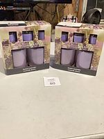 Two boxed 5-piece candle sets on table
