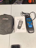 Code scanner, user manual, carry case displayed on table