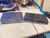 Two Toshiba units on table: VCR left, DVD player right