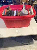 Overall view of red tote filled with DVD and CD cases